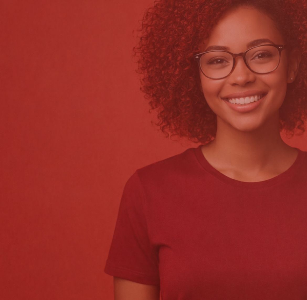 A young woman with curly hair and glasses smiles, wearing a maroon shirt. The background is a solid red color, and the image has a red tint. She is positioned slightly to the right of center.